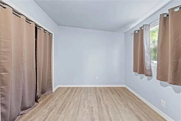 a bedroom with a large bed and a large window