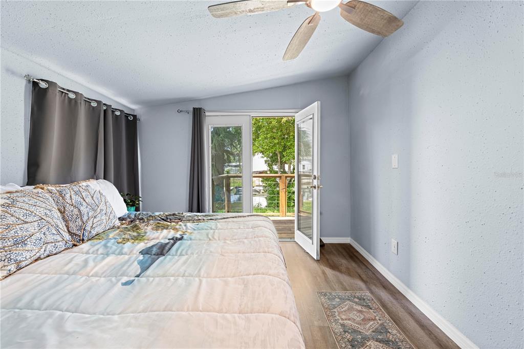 6380 Richard Drive Weeki Wachee, FL 34607 - Photo 48 of 59 a bedroom with a large bed and a large window