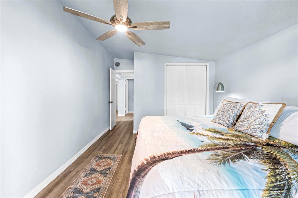 6380 Richard Drive Weeki Wachee, FL 34607 - Photo 50 of 59 a bedroom with a large bed and a chandelier