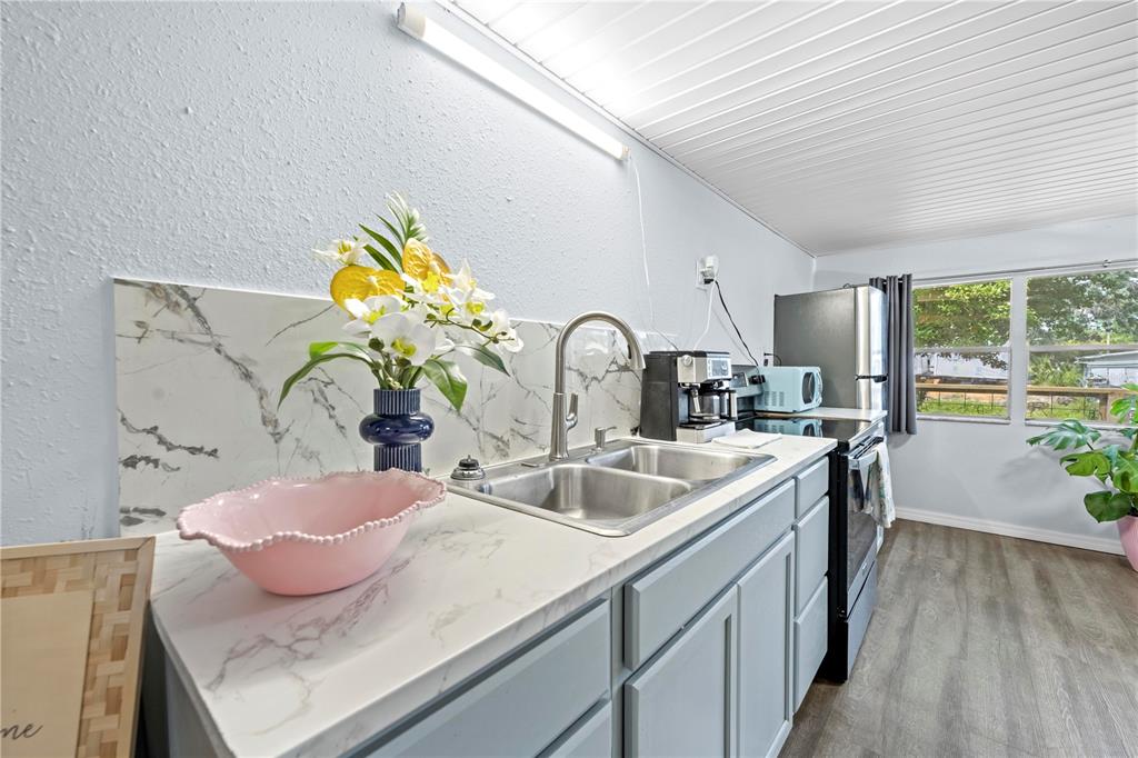 6380 Richard Drive Weeki Wachee, FL 34607 - Photo 56 of 59 a kitchen with a sink and a stove top oven
