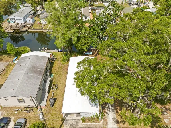 an aerial view of residential house with outdoor space and trees around