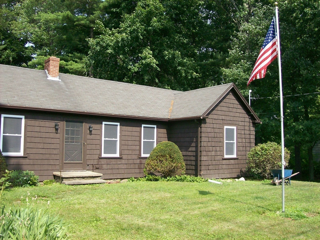 480 Pleasant Street Leicester, MA 01524 - Photo 17 of 17 a backyard of a house with potted plants and large tree