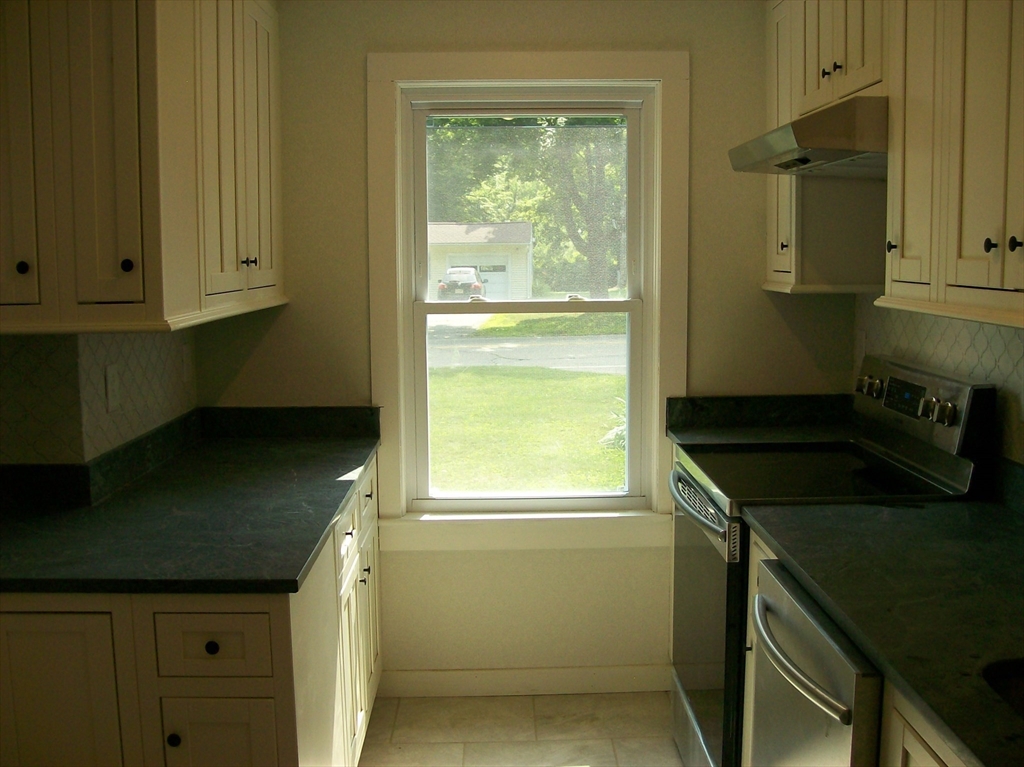 480 Pleasant Street Leicester, MA 01524 - Photo 6 of 17 a kitchen that has a sink a stove and a window