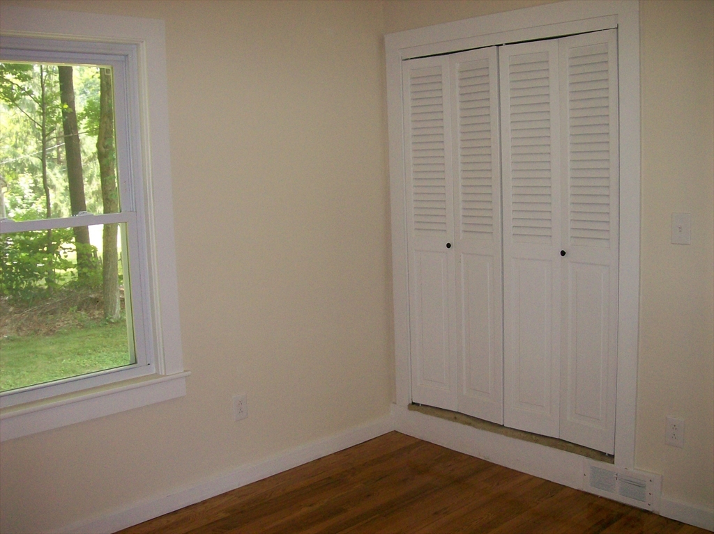 480 Pleasant Street Leicester, MA 01524 - Photo 9 of 17 a view of an empty room with wooden floor and a window