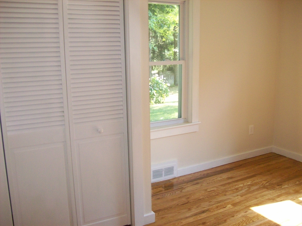 480 Pleasant Street Leicester, MA 01524 - Photo 10 of 17 a view of a small space with wooden floor and a window