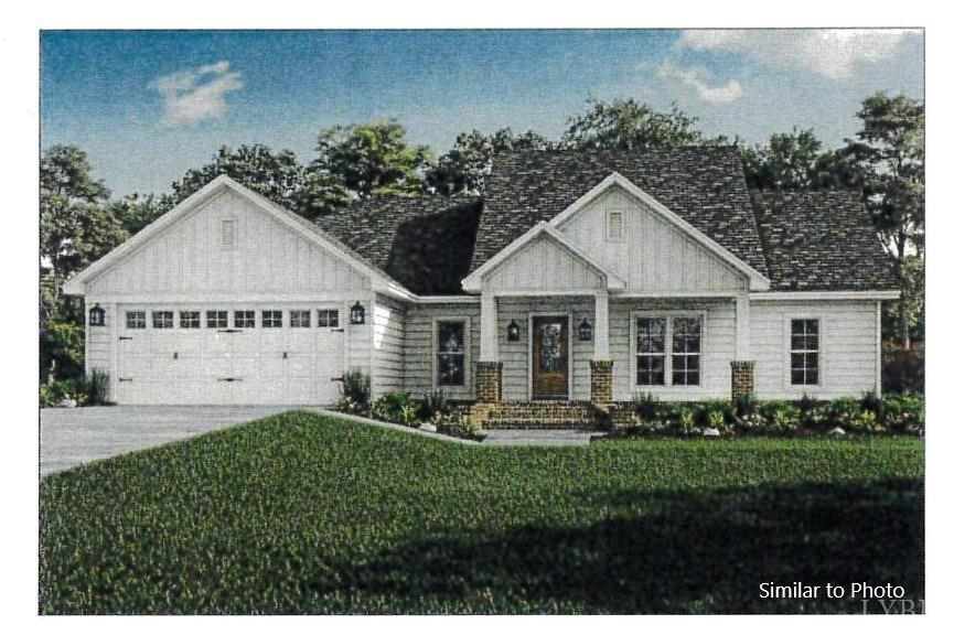 a view of a house with a yard and potted plants