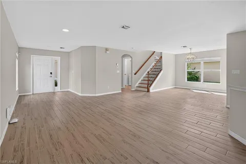 a view of a dining room with furniture wooden floor and chandelier