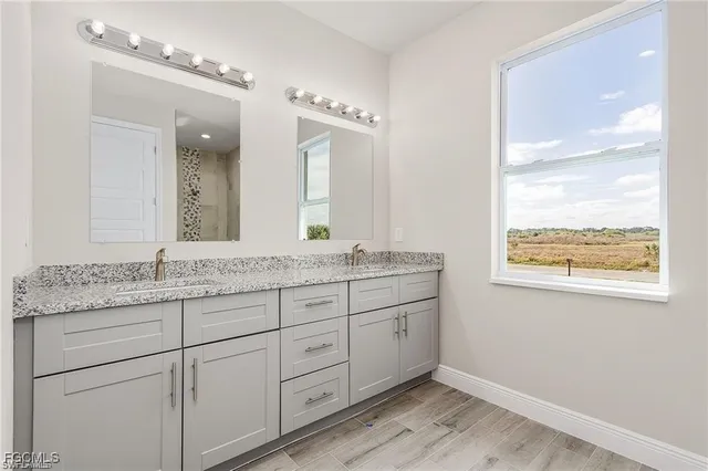 a bathroom with double sink and a mirror