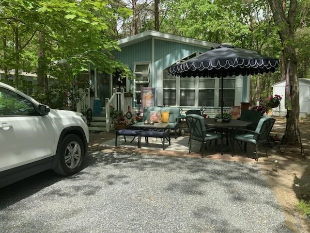 a view of a house with a patio and a yard