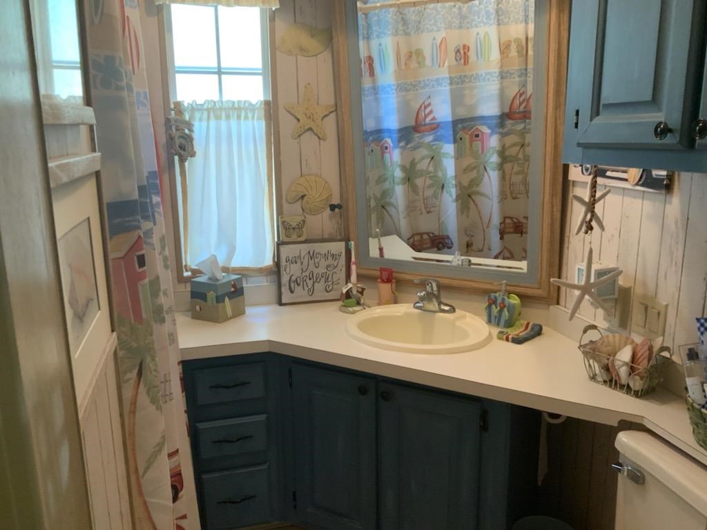 516 Highway 9 Marmora, NJ 08223 - Photo 8 of 14 a bathroom with a double vanity sink a mirror and a shower