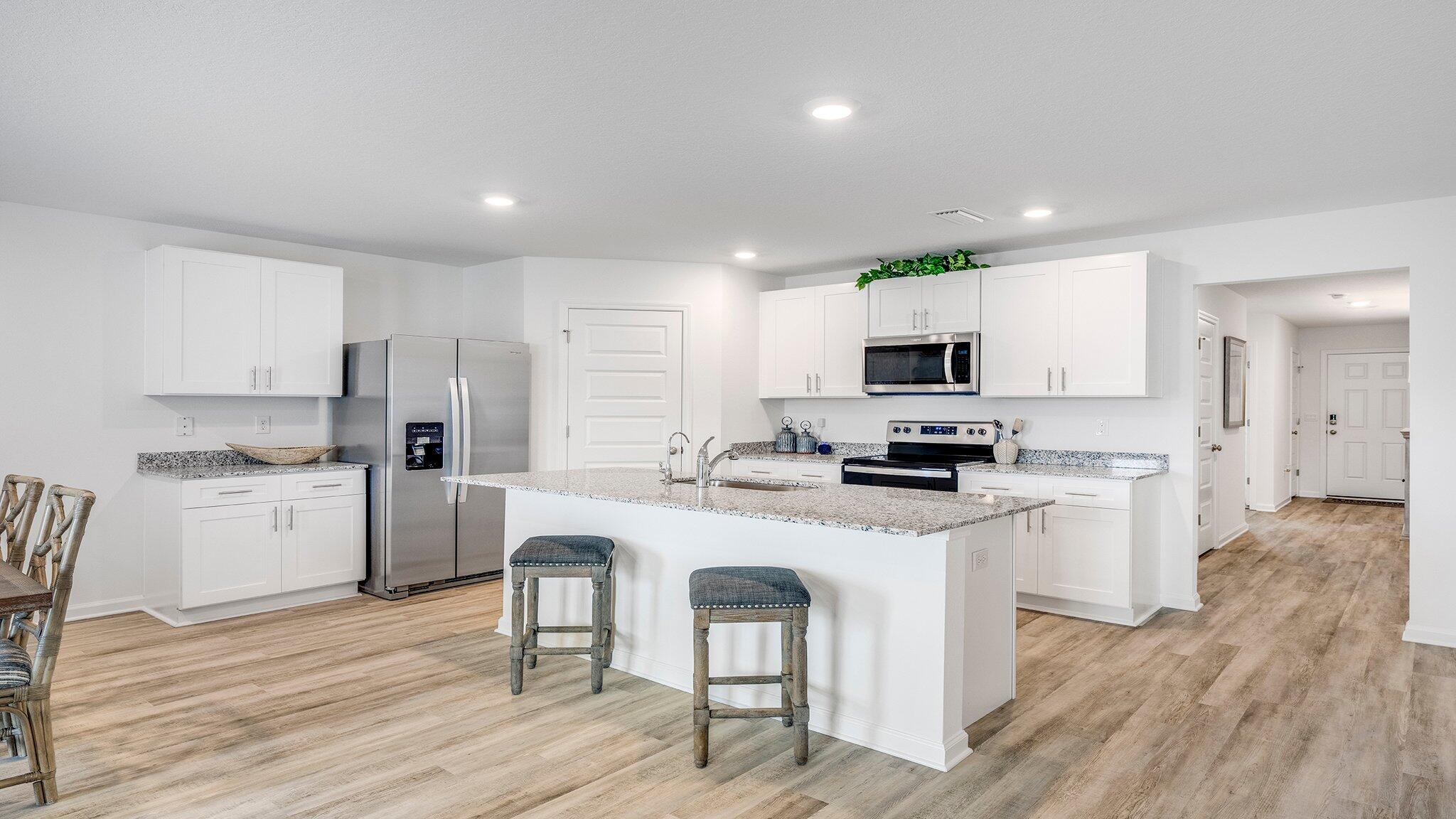8 Bluebeech Street Freeport, FL 32439 - Photo 6 of 21 a kitchen with white cabinets and stainless steel appliances