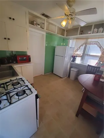 a kitchen with furniture and a stove