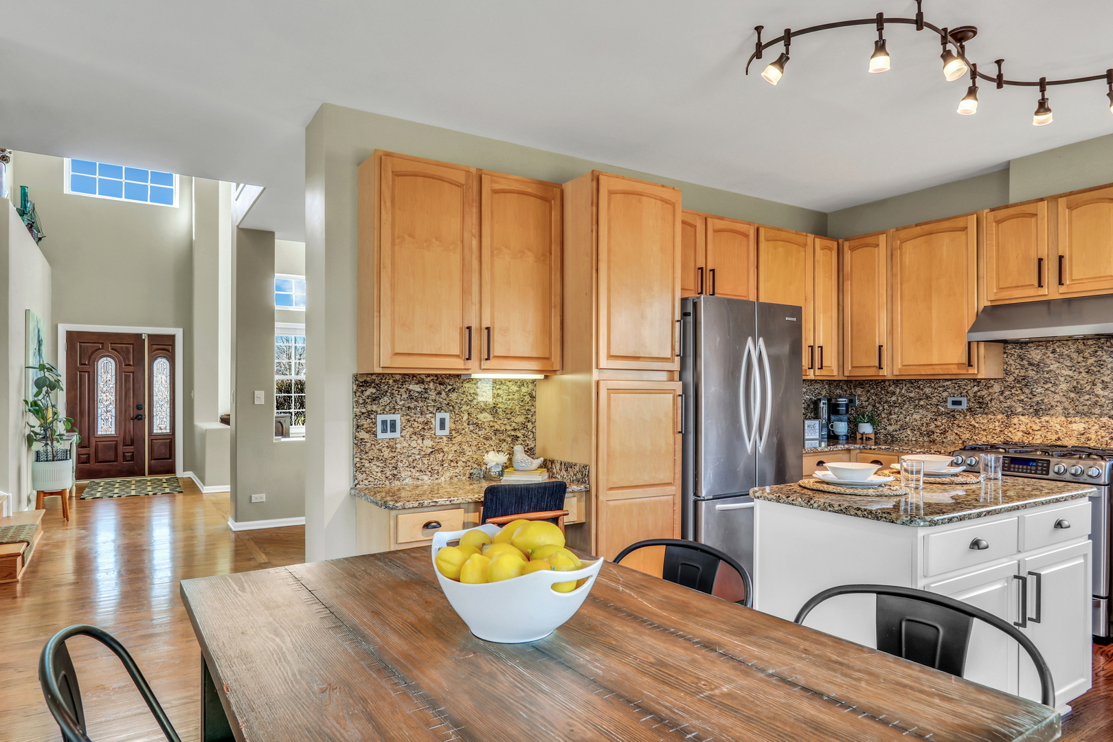 1135 Hadley Circle Gurnee, IL 60031 - Photo 13 of 60 a kitchen with stainless steel appliances granite countertop a refrigerator a stove a sink dishwasher and white cabinets with wooden floor