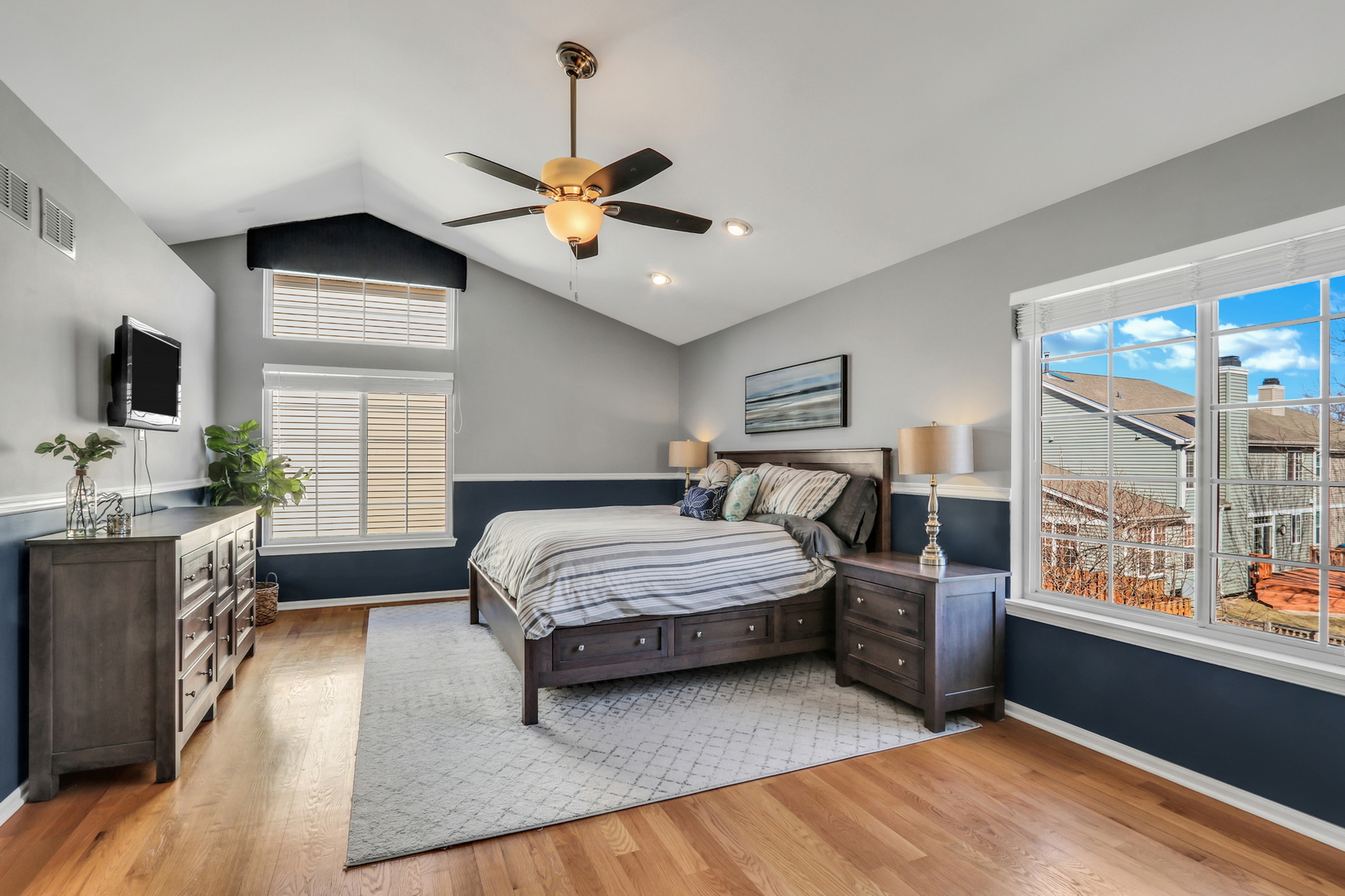 1135 Hadley Circle Gurnee, IL 60031 - Photo 32 of 60 a spacious bedroom with a large bed a chandelier and windows