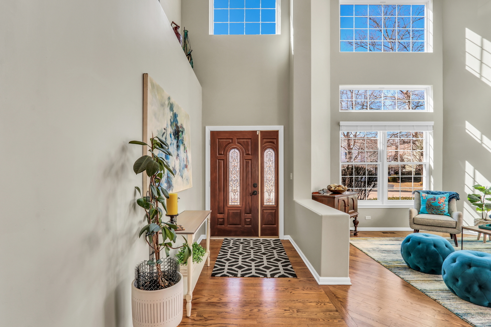 1135 Hadley Circle Gurnee, IL 60031 - Photo 5 of 60 a hallway with a dining table chairs and a potted plant