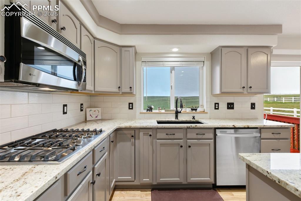 11960 Conestoga Trail South Elbert, CO 80106 - Photo 11 of 49 a kitchen with stainless steel appliances granite countertop a sink and cabinets