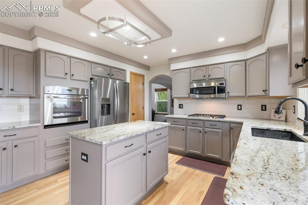 11960 Conestoga Trail South Elbert, CO 80106 - Photo 14 of 49 a kitchen with stainless steel appliances granite countertop a sink stove and refrigerator