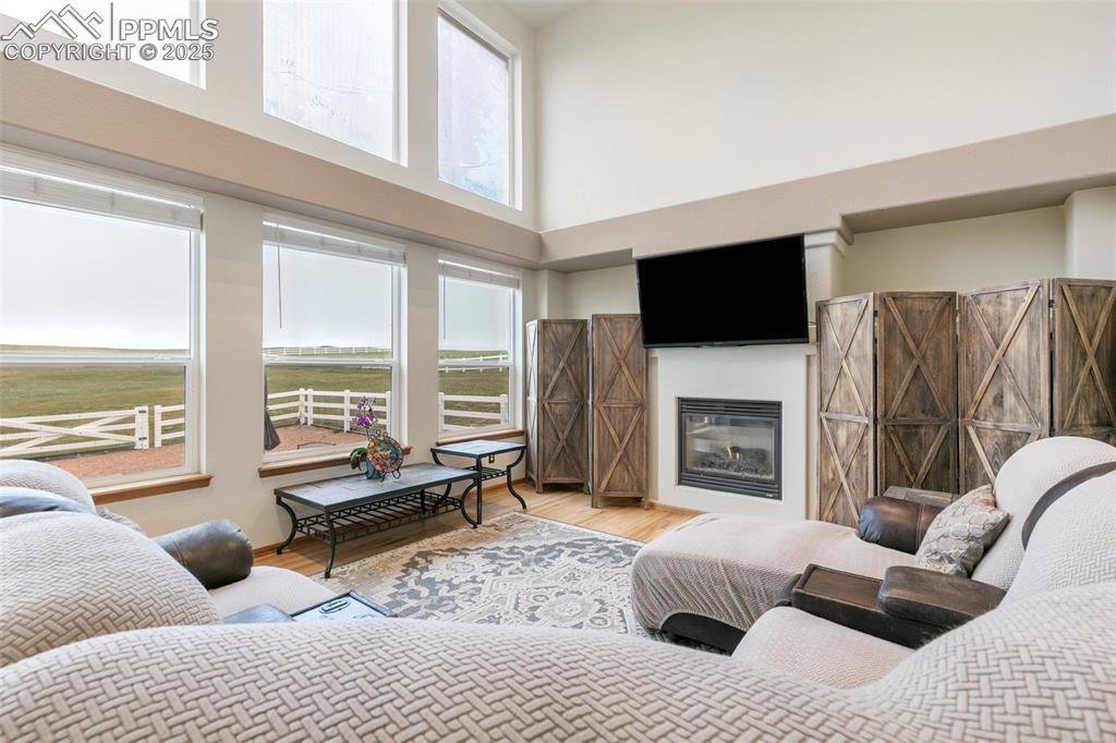 11960 Conestoga Trail South Elbert, CO 80106 - Photo 17 of 49 a living room with furniture a fireplace and a flat screen tv