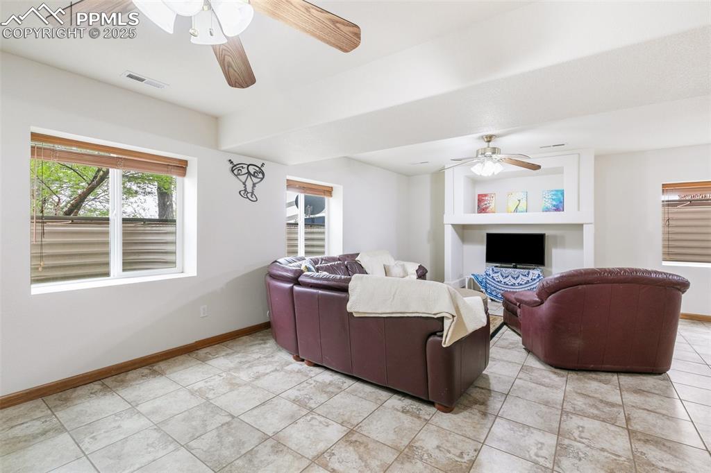 11960 Conestoga Trail South Elbert, CO 80106 - Photo 28 of 49 a living room with furniture and a fireplace