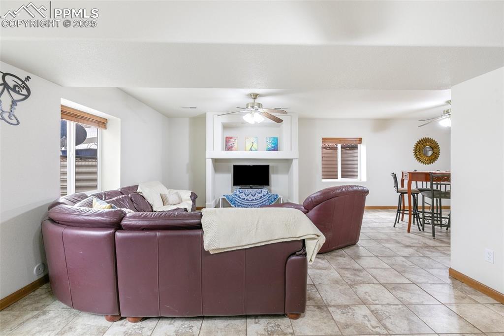 11960 Conestoga Trail South Elbert, CO 80106 - Photo 29 of 49 a living room with furniture and a fireplace