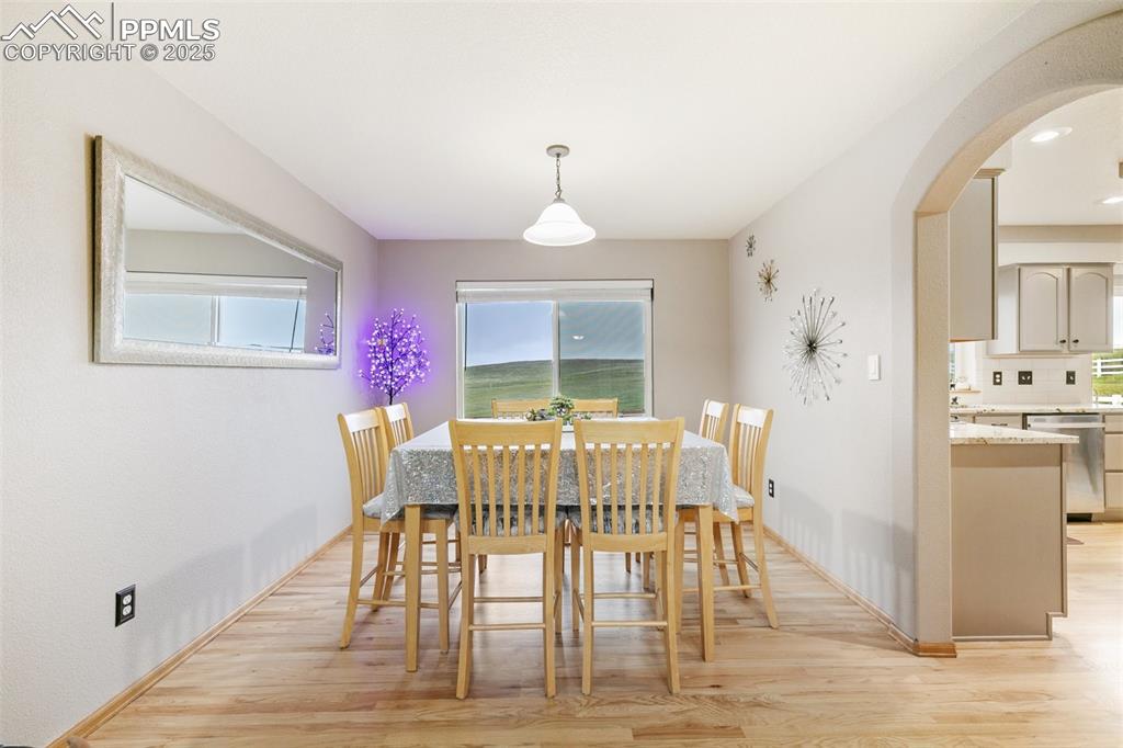11960 Conestoga Trail South Elbert, CO 80106 - Photo 8 of 49 a view of a dining room with furniture window and wooden floor