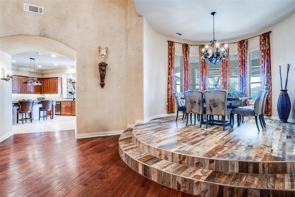 1929 Canyon Road Celina, TX 75009 - Photo 12 of 39 Dining room featuring a chandelier, arched walkways, and hardwood / wood-style floors