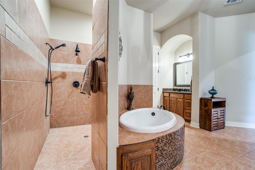 1929 Canyon Road Celina, TX 75009 - Photo 24 of 39 Full bathroom featuring vanity, a garden tub, tiled shower, and light tile patterned floors