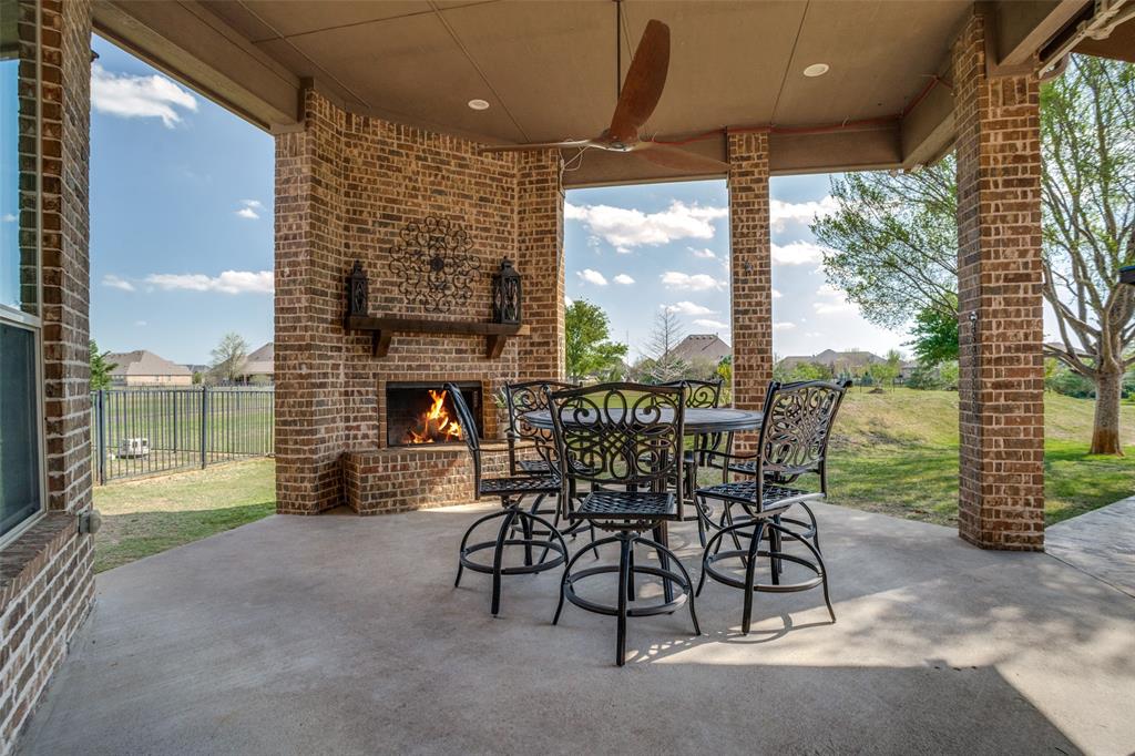 1929 Canyon Road Celina, TX 75009 - Photo 27 of 39 View of patio / terrace featuring an outdoor brick fireplace, outdoor dining area, and ceiling fan