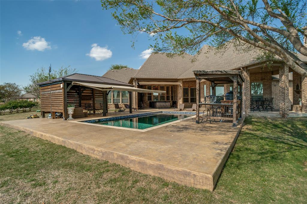 1929 Canyon Road Celina, TX 75009 - Photo 33 of 39 Back of property featuring a patio, an outdoor pool, brick siding, and a yard