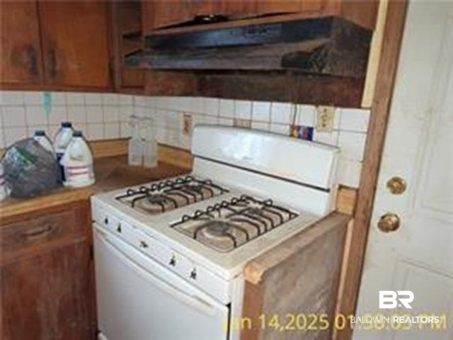 233 Grant Circle Mobile, AL 36610 - Photo 4 of 10 Kitchen with backsplash and white gas stove