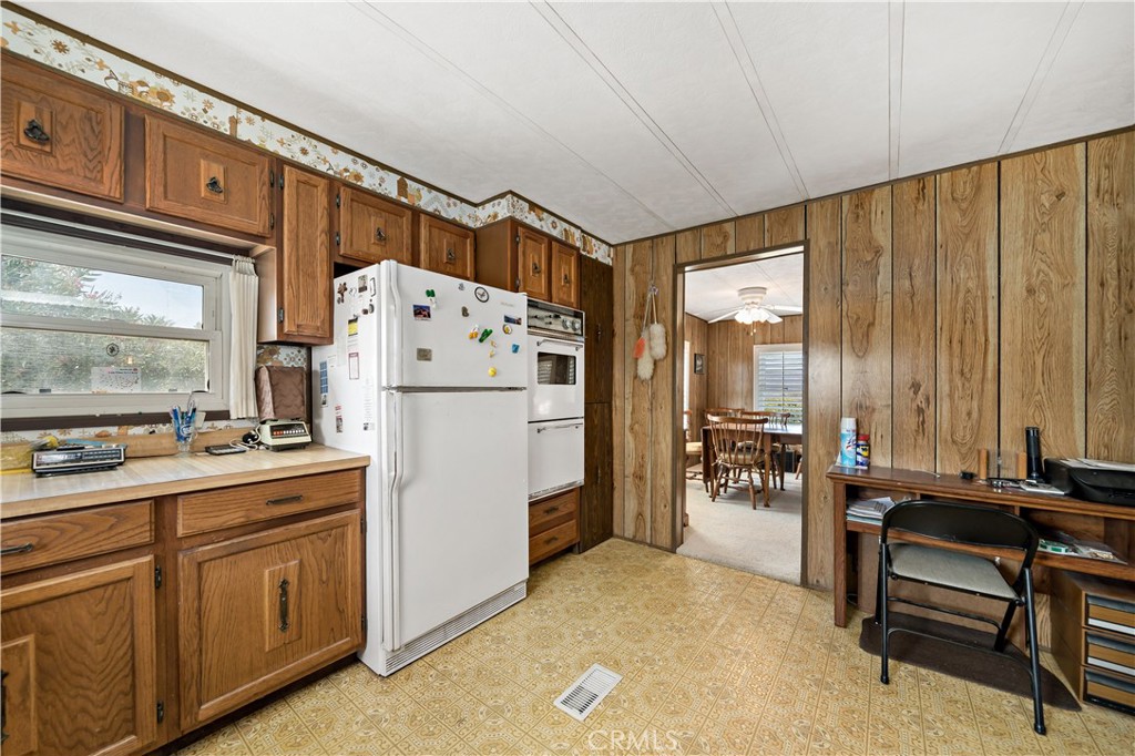 33950 Plowshare Road Wildomar, CA 92595 - Photo 28 of 62 a kitchen with refrigerator and cabinets