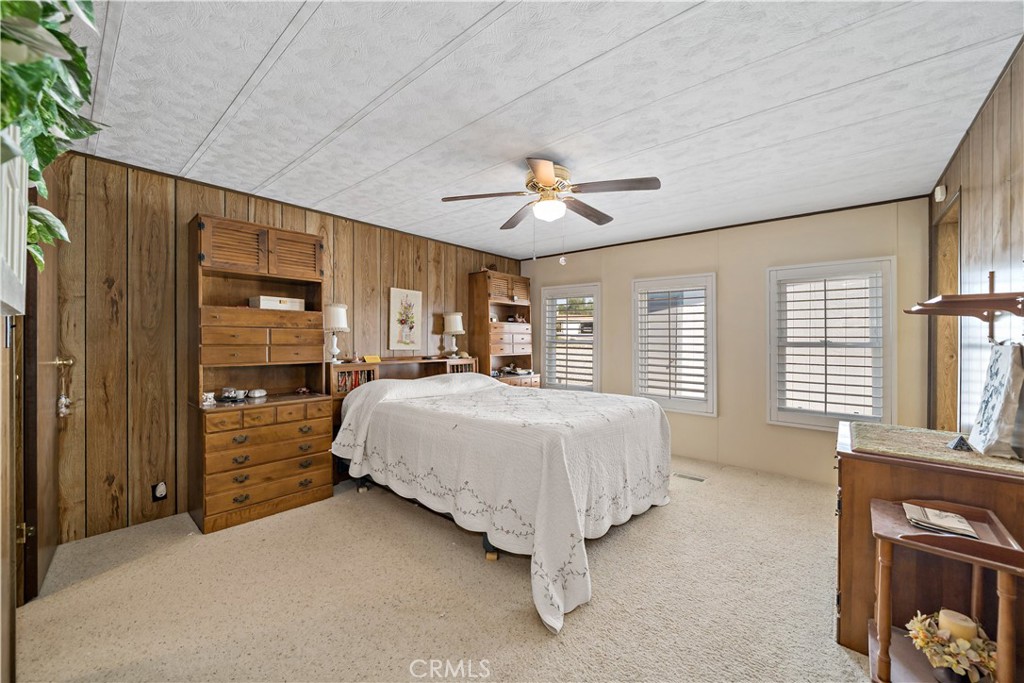 33950 Plowshare Road Wildomar, CA 92595 - Photo 29 of 62 a spacious bedroom with a bed and a window