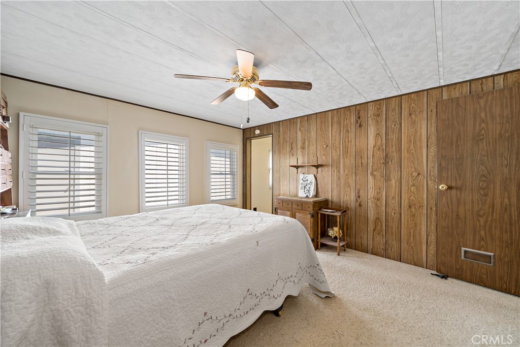 33950 Plowshare Road Wildomar, CA 92595 - Photo 30 of 62 a bedroom with a large bed and a chandelier