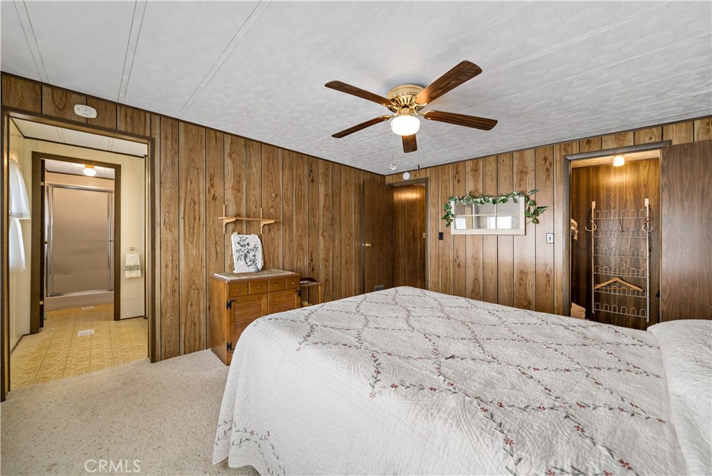 33950 Plowshare Road Wildomar, CA 92595 - Photo 31 of 62 a bedroom with a large bed and a chandelier