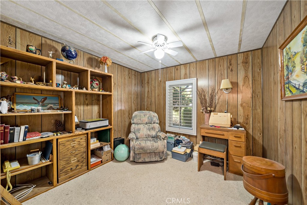 33950 Plowshare Road Wildomar, CA 92595 - Photo 34 of 62 a living room with furniture cabinets and a book shelf