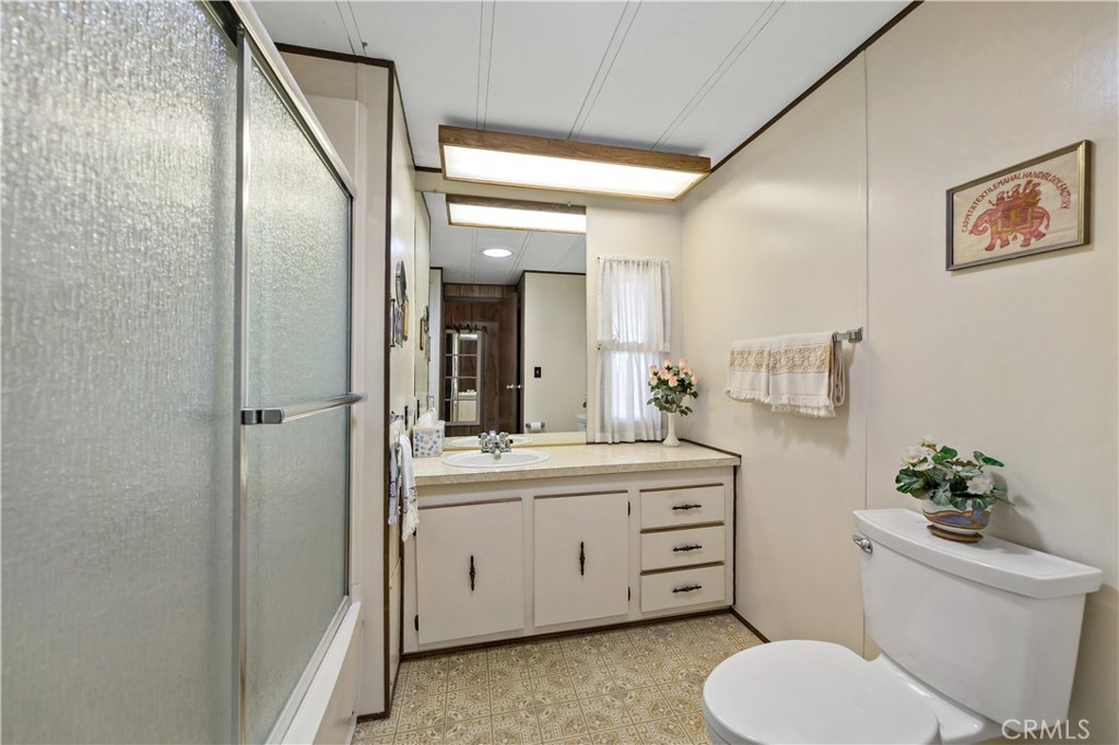 33950 Plowshare Road Wildomar, CA 92595 - Photo 35 of 62 a bathroom with a toilet a sink and mirror