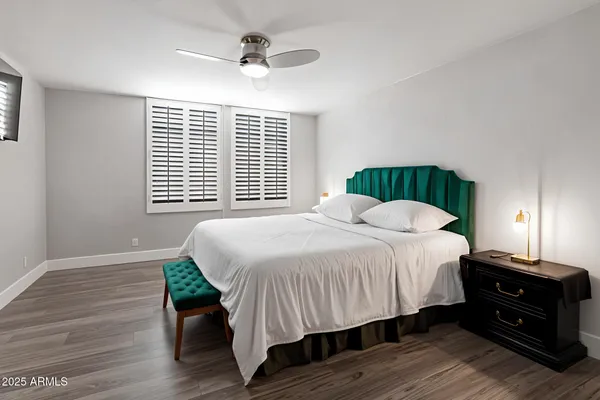 a bedroom with a bed and wooden floor