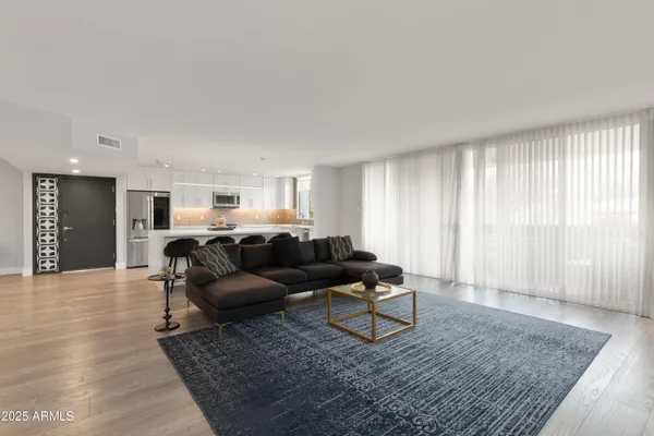 a living room with furniture and a rug