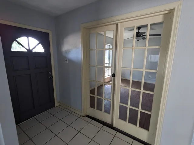a view of an entryway with wooden floor and windows
