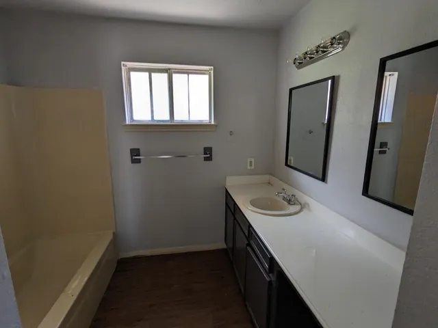 a bathroom with a sink a vanity and a mirror