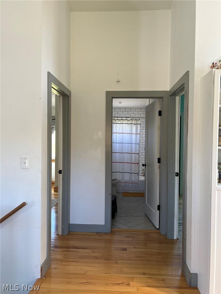 15393 Shade Road Guysville, OH 45735 - Photo 9 of 35 Hardwood flooring extending through a hallway with multiple doorways