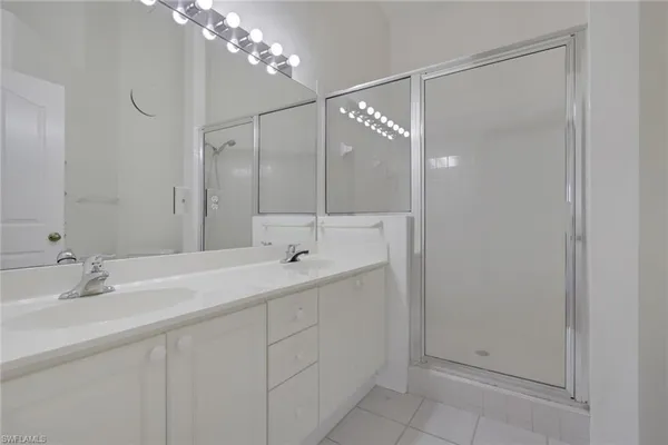 a bathroom with a shower sink and mirror