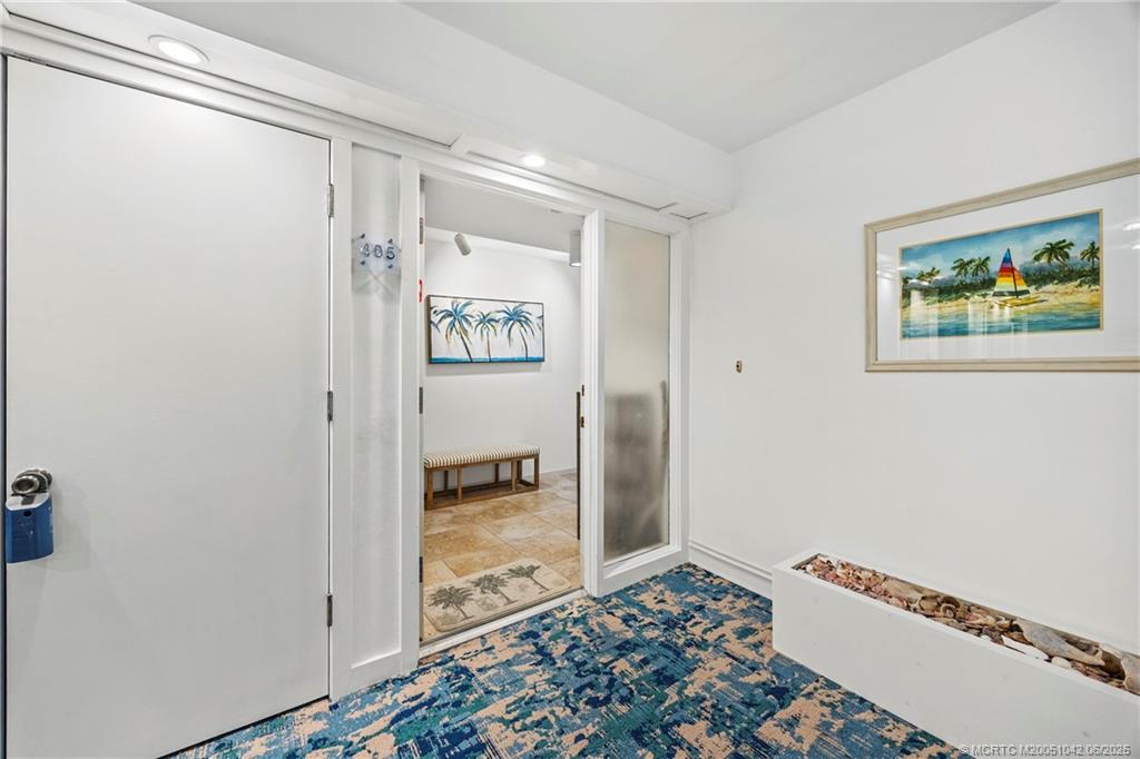 669 Northeast Plantation Road, Unit 405 Stuart, FL 34996 - Photo 12 of 34 a view of a hallway with closet and wooden floor