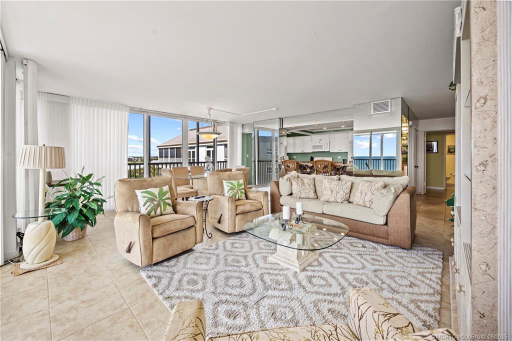 669 Northeast Plantation Road, Unit 405 Stuart, FL 34996 - Photo 15 of 34 a living room with furniture and a table