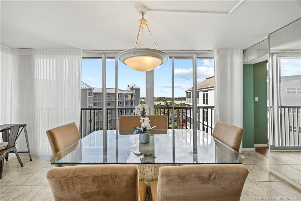 669 Northeast Plantation Road, Unit 405 Stuart, FL 34996 - Photo 19 of 34 a view of a dining room with furniture window and outside view