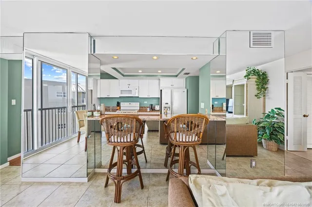 a kitchen with granite countertop a sink and a refrigerator