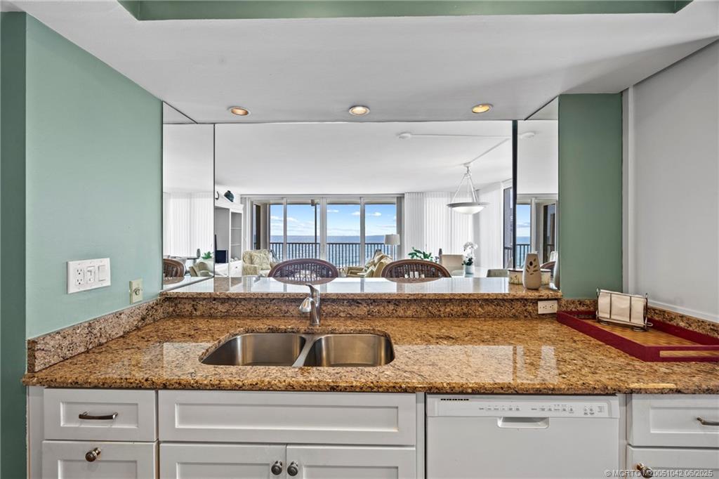 669 Northeast Plantation Road, Unit 405 Stuart, FL 34996 - Photo 22 of 34 a view with a sink and mirror