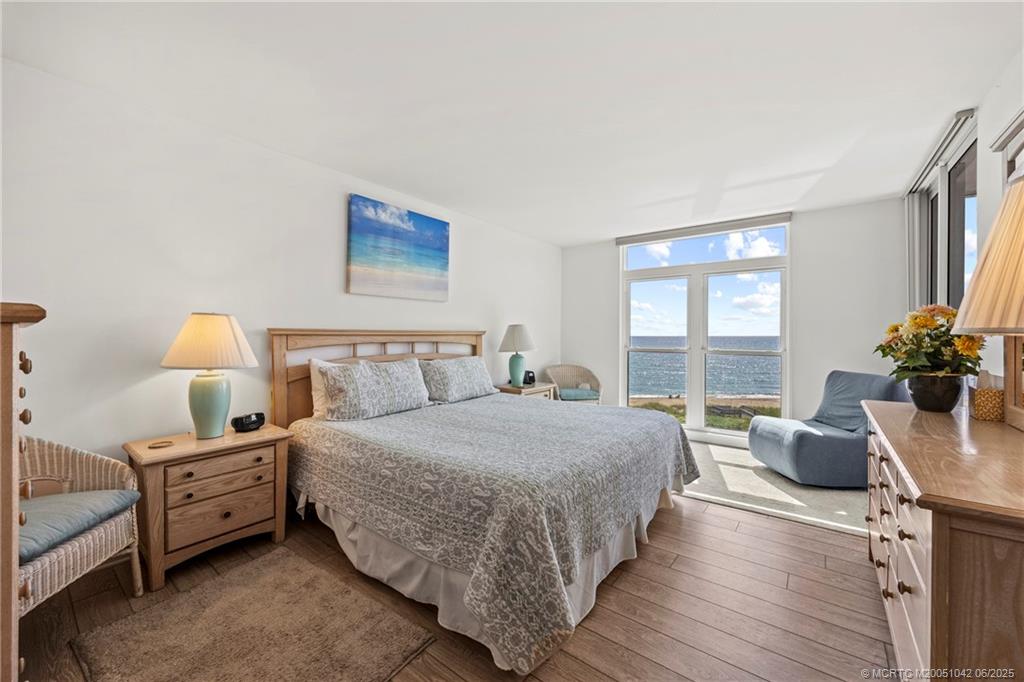 669 Northeast Plantation Road, Unit 405 Stuart, FL 34996 - Photo 24 of 34 a bedroom with a bed and a couch