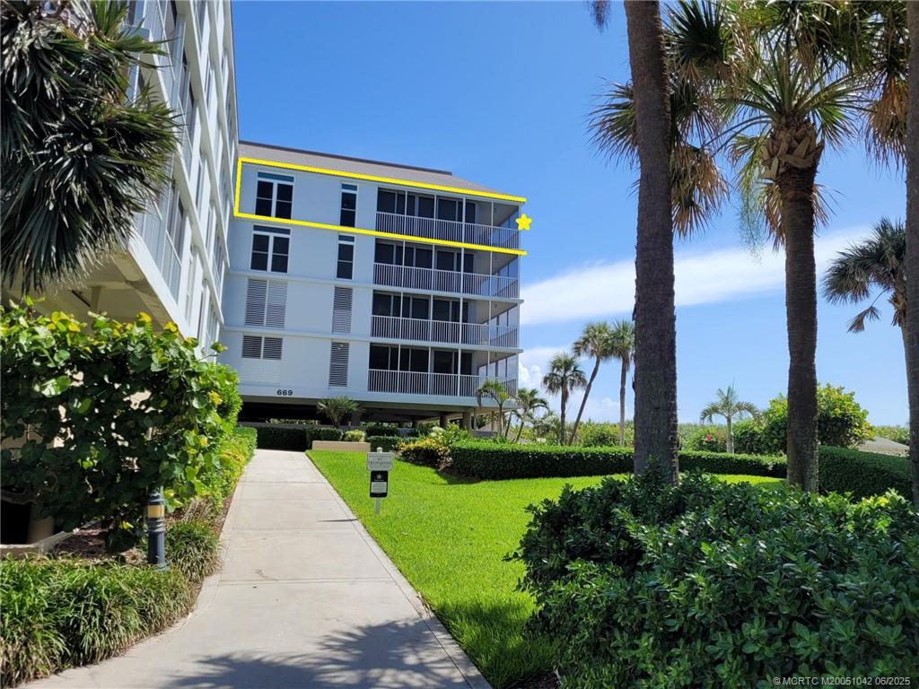 669 Northeast Plantation Road, Unit 405 Stuart, FL 34996 - Photo 5 of 34 a view of a building with a yard