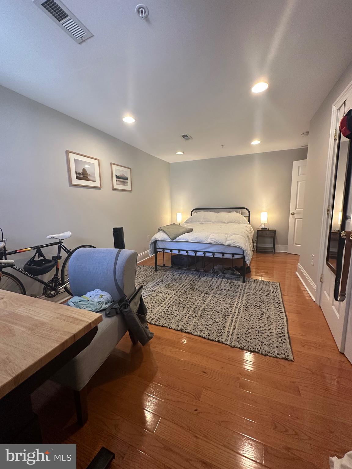 1014 Clinton Street, Unit 1R Philadelphia, PA 19107 - Photo 9 of 14 a bedroom with a bed and wooden floor